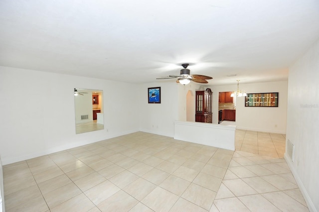 unfurnished living room with ceiling fan with notable chandelier and light tile patterned flooring