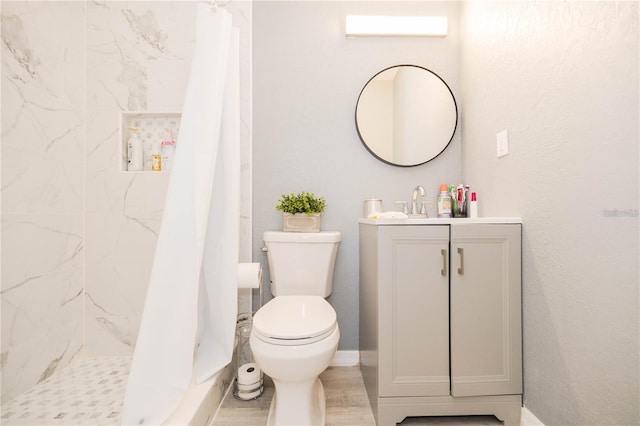 bathroom featuring a shower with curtain, toilet, and vanity