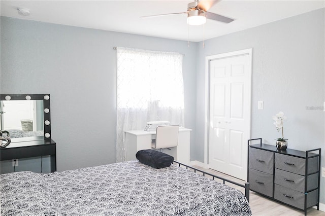 bedroom with ceiling fan and light hardwood / wood-style flooring