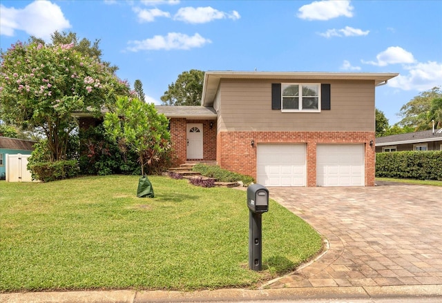 view of front of home with a front yard and a garage