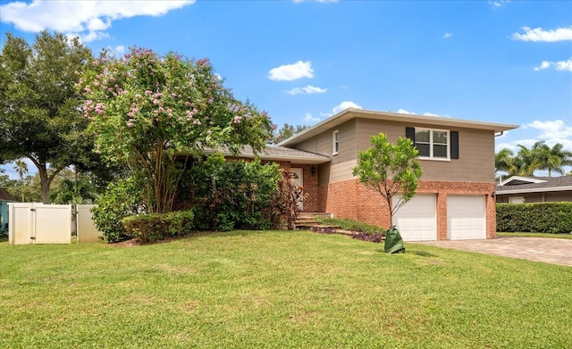 split level home featuring a garage and a front lawn