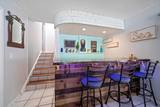 8212 Forest Cir, Seminole, FL 33776 - indoor bar with stairs, crown molding, baseboards, and tile patterned floors