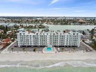 birds eye view of property with a water view and a view of the beach