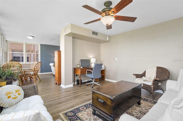 living room featuring ceiling fan and light hardwood / wood-style floors