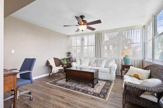 living room featuring hardwood / wood-style flooring and ceiling fan