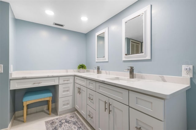 bathroom with tile patterned floors and vanity