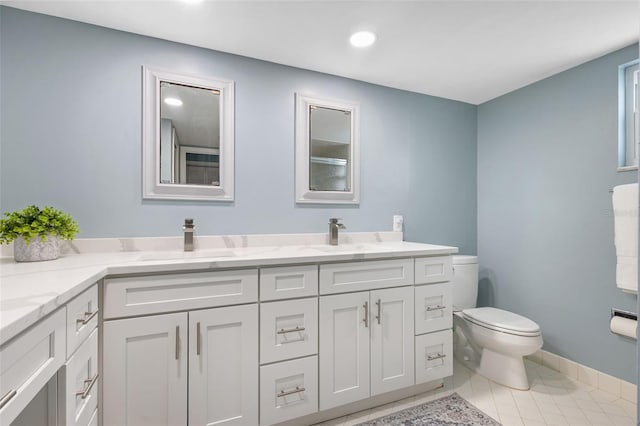 bathroom with tile patterned flooring, vanity, and toilet