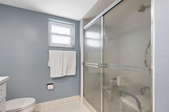 bathroom featuring vanity, toilet, tile patterned floors, and a shower with door