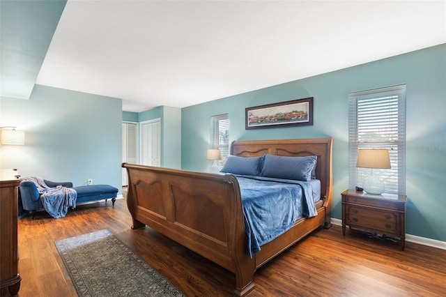 bedroom with a closet and dark hardwood / wood-style floors