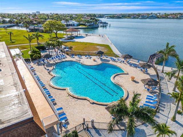 view of pool with a water view and a patio area