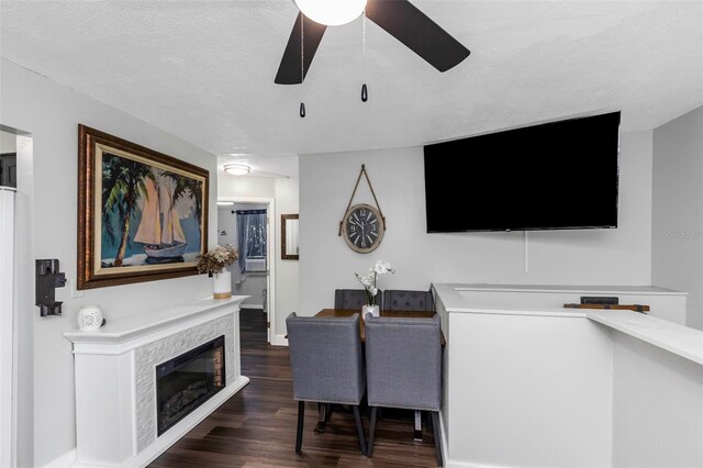 7331/2 New Jersey St, Clearwater, FL 33756 - living area with a textured ceiling, a ceiling fan, baseboards, wood finished floors, and a high end fireplace