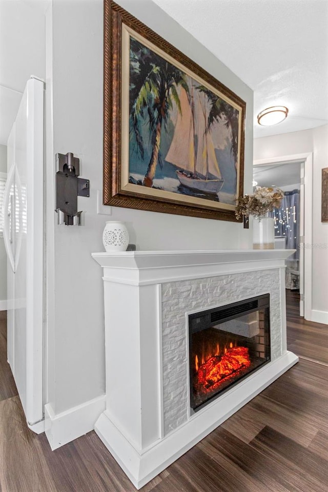 7331/2 New Jersey St, Clearwater, FL 33756 - interior details with a glass covered fireplace, baseboards, and wood finished floors