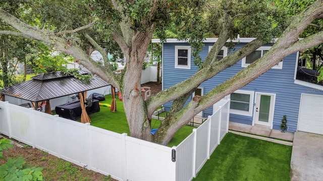 7331/2 New Jersey St, Clearwater, FL 33756 - rear view of house featuring a lawn, a fenced backyard, and a garage