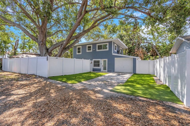 7331/2 New Jersey St, Clearwater, FL 33756 - view of front of house featuring driveway, a fenced backyard, a front yard, and a garage