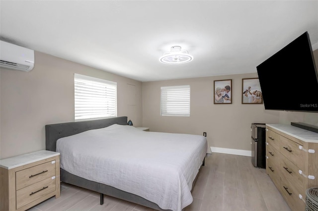 7331/2 New Jersey St, Clearwater, FL 33756 - bedroom featuring baseboards, light wood finished floors, and a wall mounted air conditioner