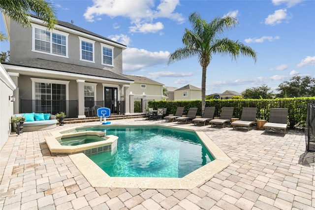 view of pool with an in ground hot tub and a patio area