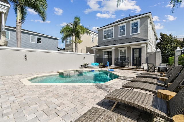 view of swimming pool featuring an in ground hot tub and a patio