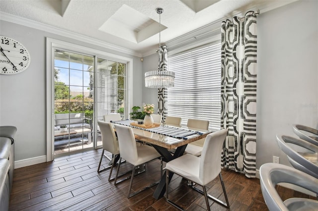 dining room with ornamental molding, a chandelier, a textured ceiling, and dark hardwood / wood-style flooring