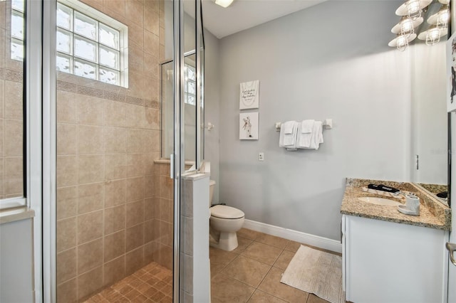 bathroom featuring vanity, a shower with shower door, toilet, and tile patterned flooring