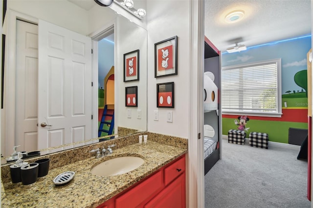 bathroom featuring a textured ceiling and vanity