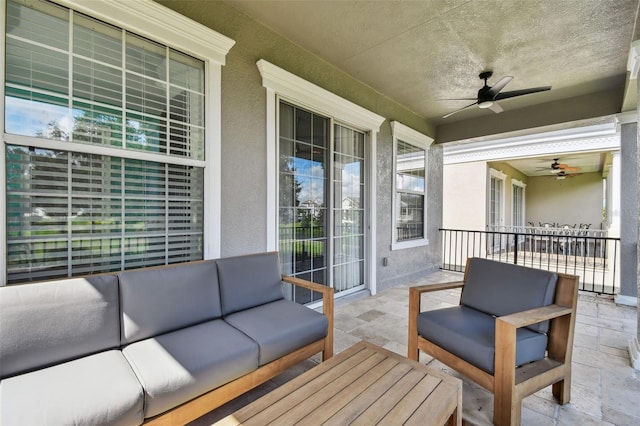 balcony featuring a patio, ceiling fan, and outdoor lounge area