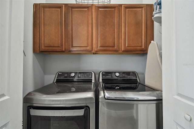 laundry room with cabinets and separate washer and dryer