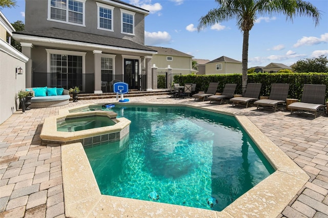 view of pool featuring an in ground hot tub and a patio area