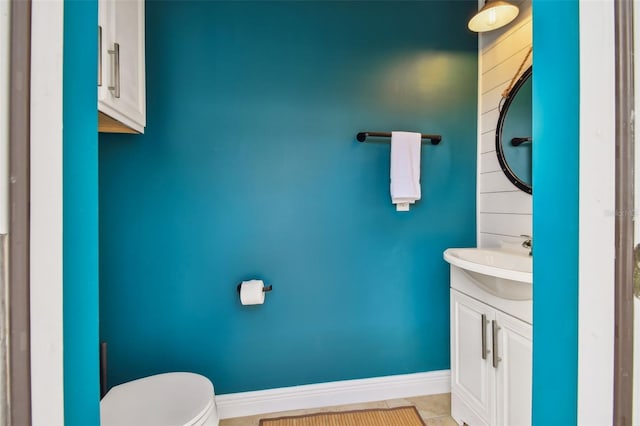 bathroom featuring tile patterned flooring, vanity, and toilet