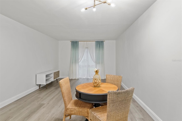 10800 US Highway 19 N Unit 112, Pinellas Park, FL 33782 - dining space with a chandelier, light wood-style floors, and baseboards