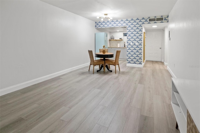 10800 US Highway 19 N Unit 112, Pinellas Park, FL 33782 - dining area featuring light wood-style floors, a chandelier, and baseboards