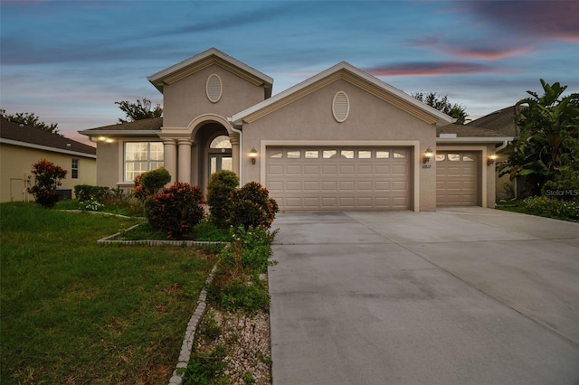 view of front of property featuring a yard and a garage