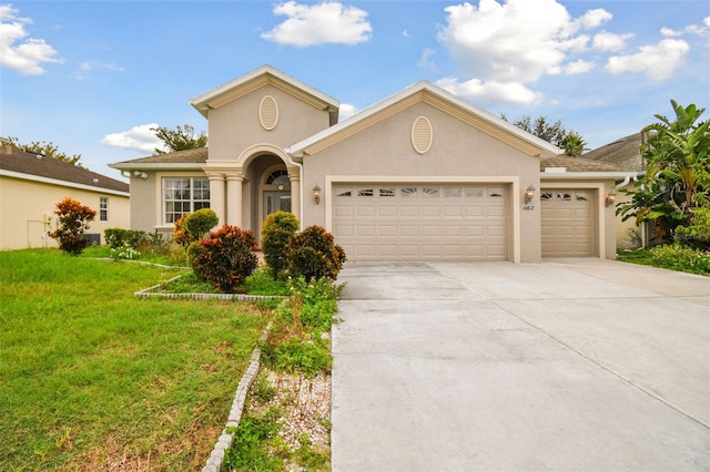 view of front of property with a garage and a front yard