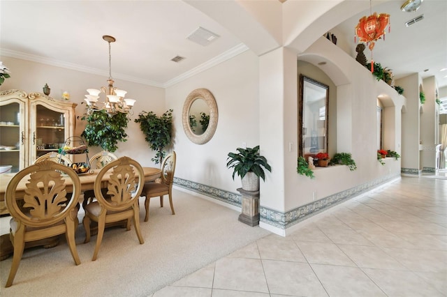 carpeted dining room featuring crown molding and a chandelier