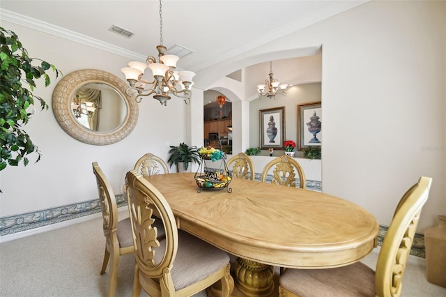 dining space with crown molding, carpet flooring, and an inviting chandelier