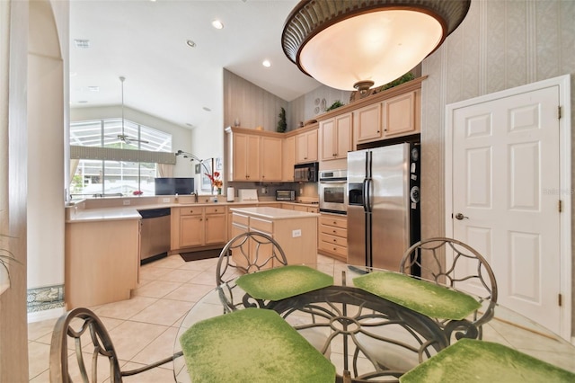 kitchen featuring a kitchen island, light brown cabinetry, light tile patterned floors, appliances with stainless steel finishes, and sink