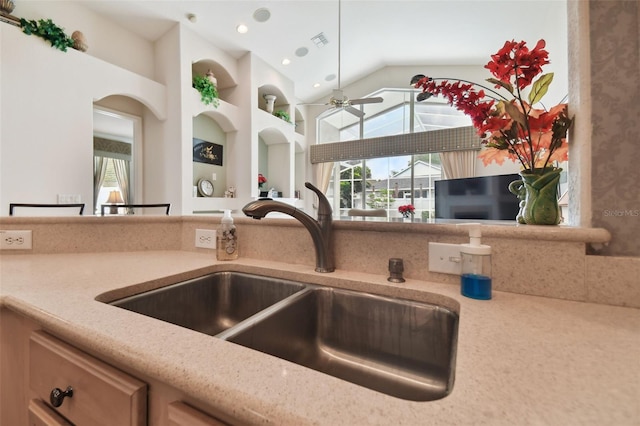 kitchen featuring built in features, ceiling fan, lofted ceiling, and sink