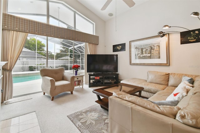 carpeted living room with ceiling fan