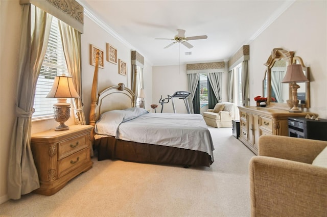 bedroom with multiple windows, ceiling fan, crown molding, and light carpet