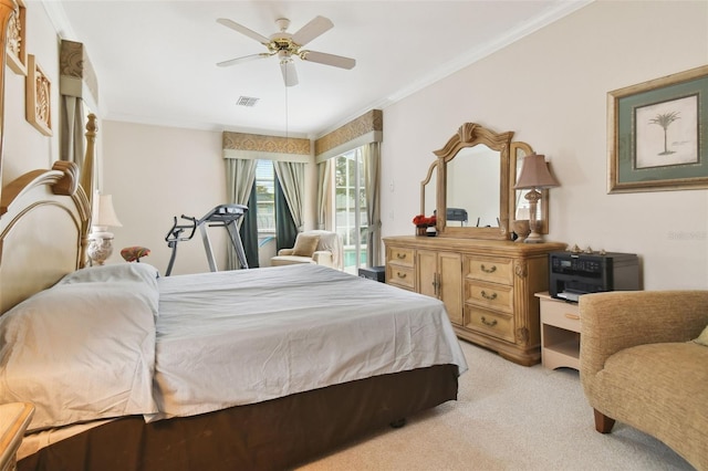 carpeted bedroom with ornamental molding and ceiling fan