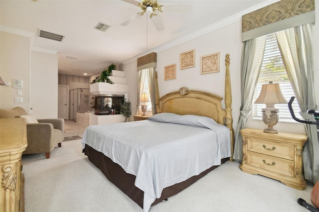 bedroom featuring carpet flooring, ceiling fan, ornamental molding, and a multi sided fireplace