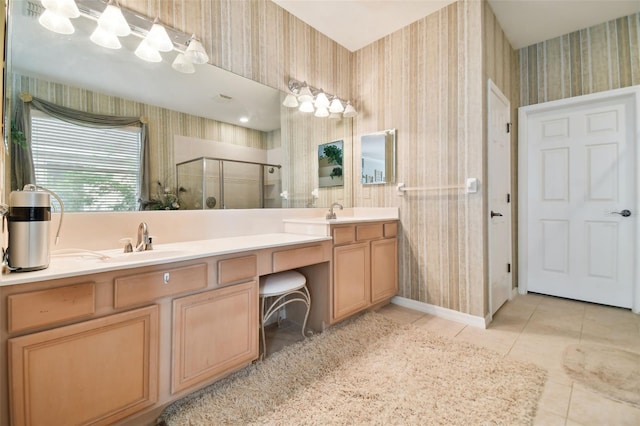 bathroom featuring tile patterned flooring, an enclosed shower, and vanity