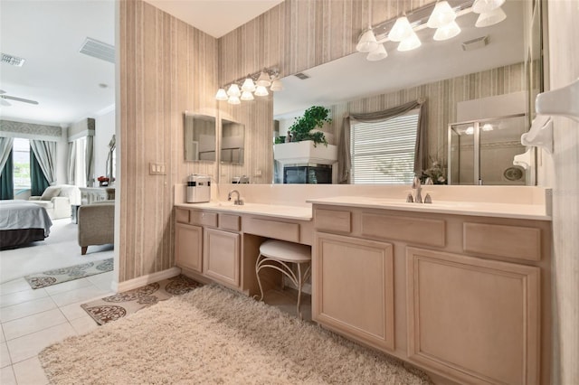 bathroom with tile patterned floors, ceiling fan, an enclosed shower, and vanity