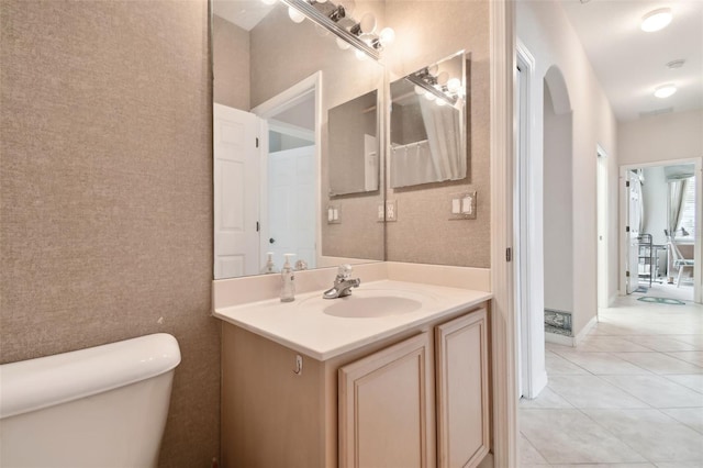 bathroom with vanity, toilet, and tile patterned floors