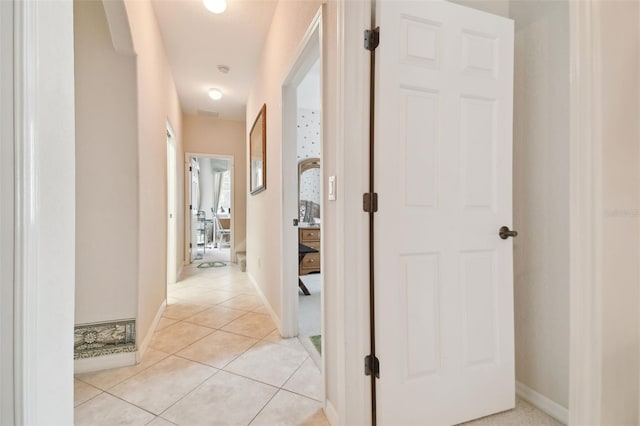 hall with light tile patterned floors