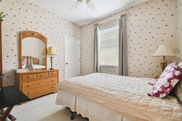 bedroom featuring ceiling fan and carpet