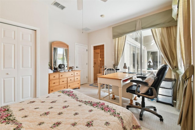 bedroom featuring ceiling fan, light colored carpet, and a closet