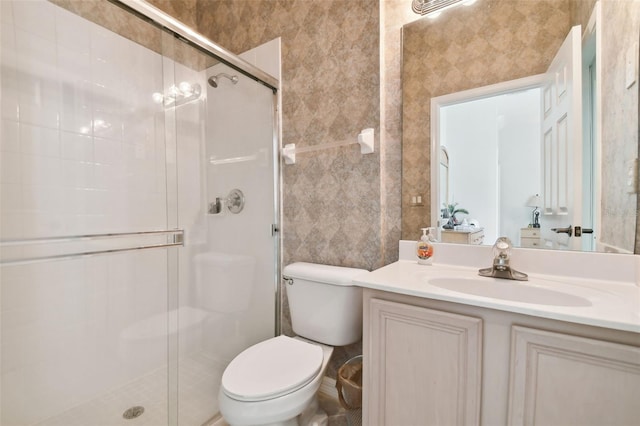 bathroom featuring walk in shower, toilet, and vanity