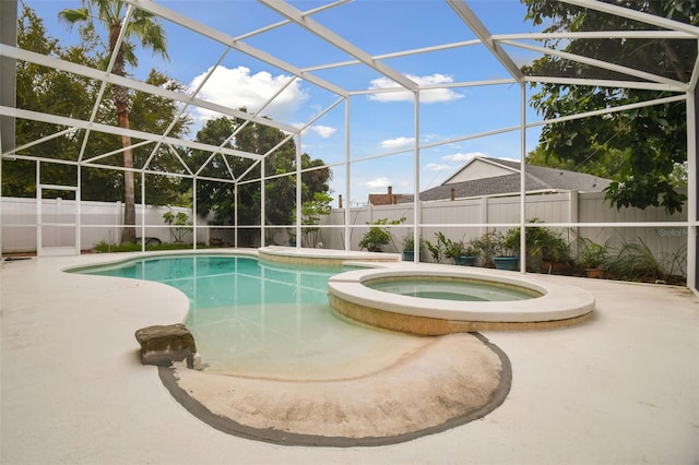 view of pool with a lanai, a patio, and an in ground hot tub