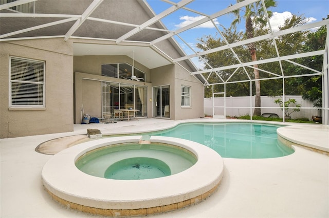 view of pool with an in ground hot tub, a patio, and a lanai