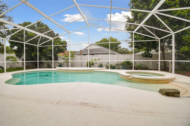 view of swimming pool featuring a lanai, a patio, and an in ground hot tub